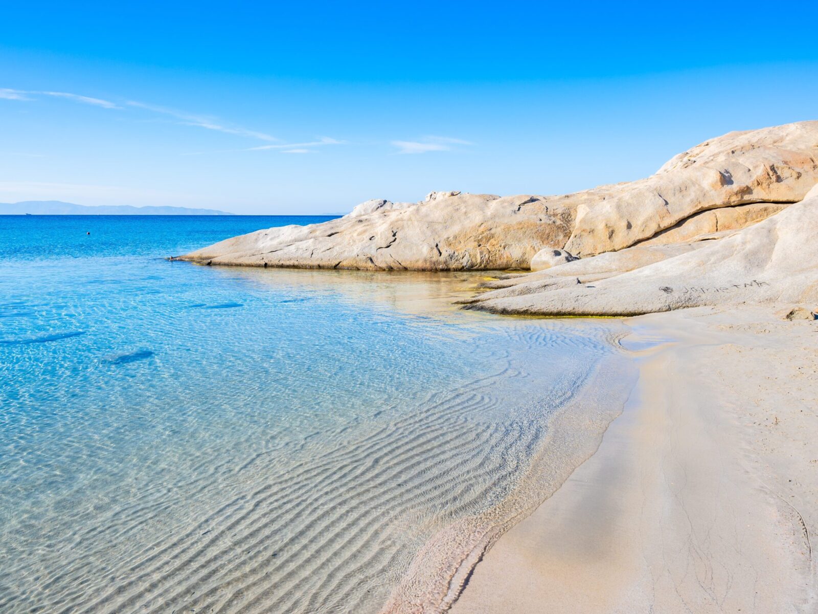 Beautiful,Sandy,Beach,Of,Mikri,Vigla,With,Rocks,In,Azure