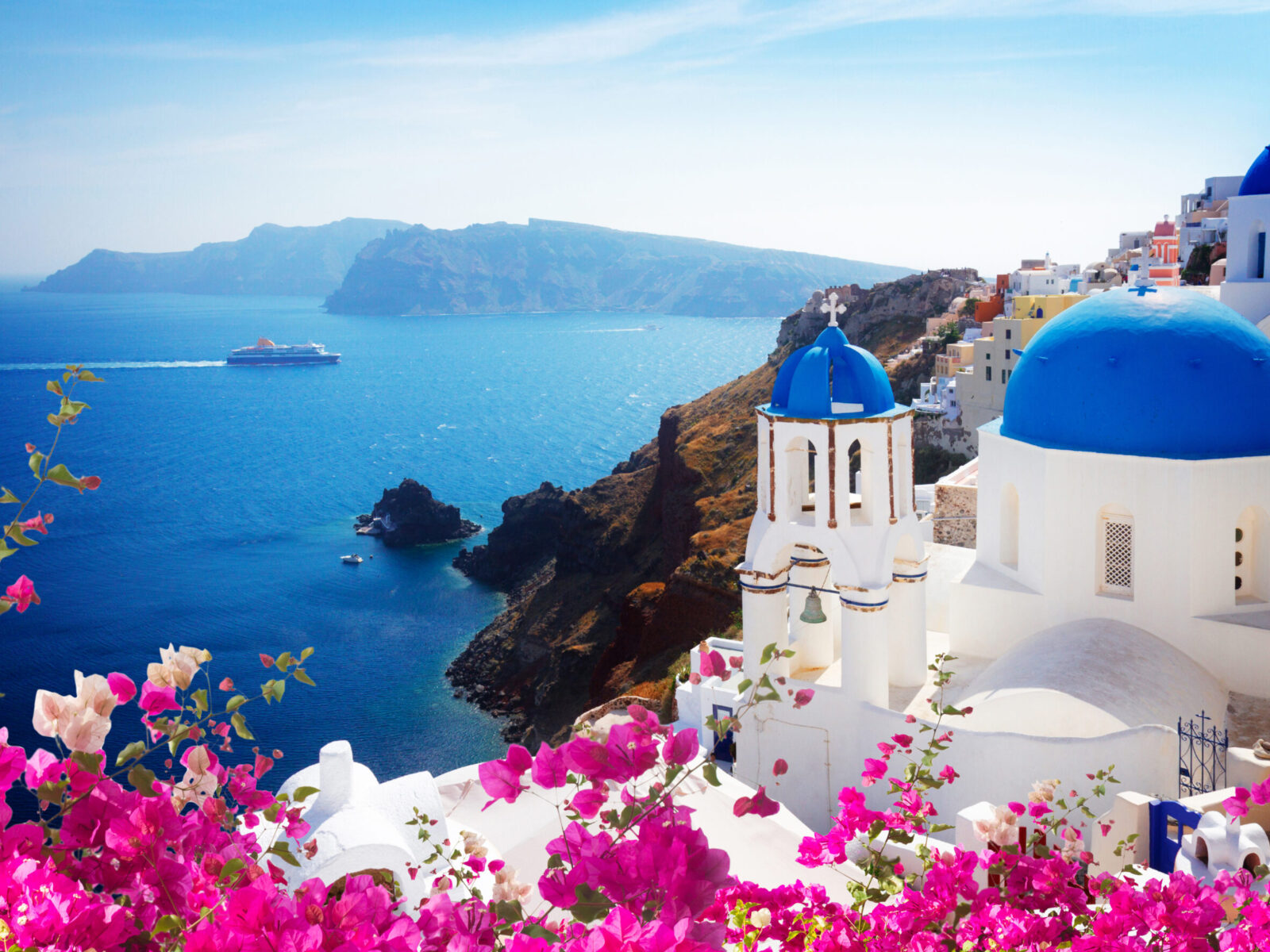 Volcano,Caldera,With,Blue,Church,Domes,,Oia,With,Flowers,,Santorini,