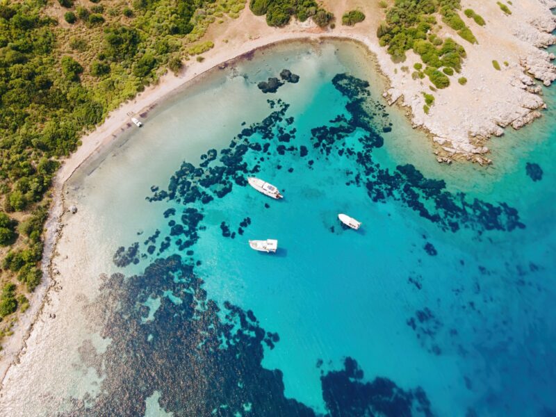 Aerial,View,Of,Blue,Sea,Lagoon,And,Yachts,Along,The