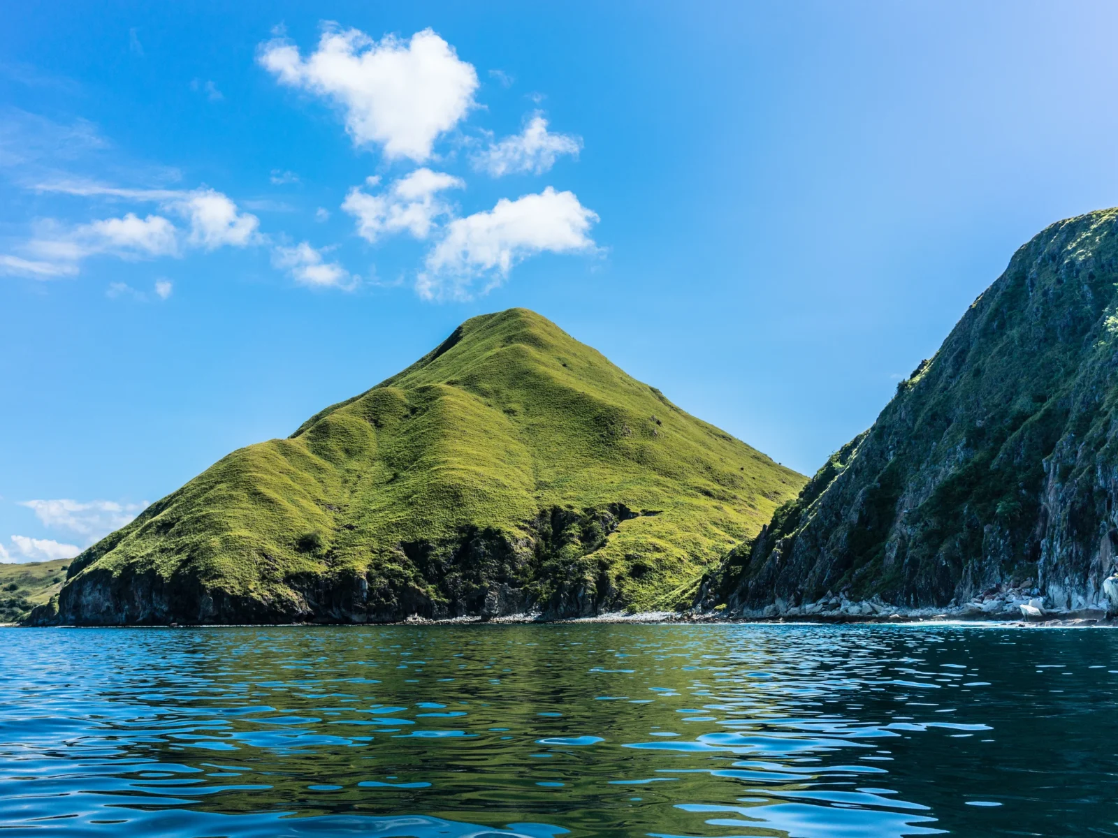 Indonesia-Padar Island-blue skies, waters, green mountain